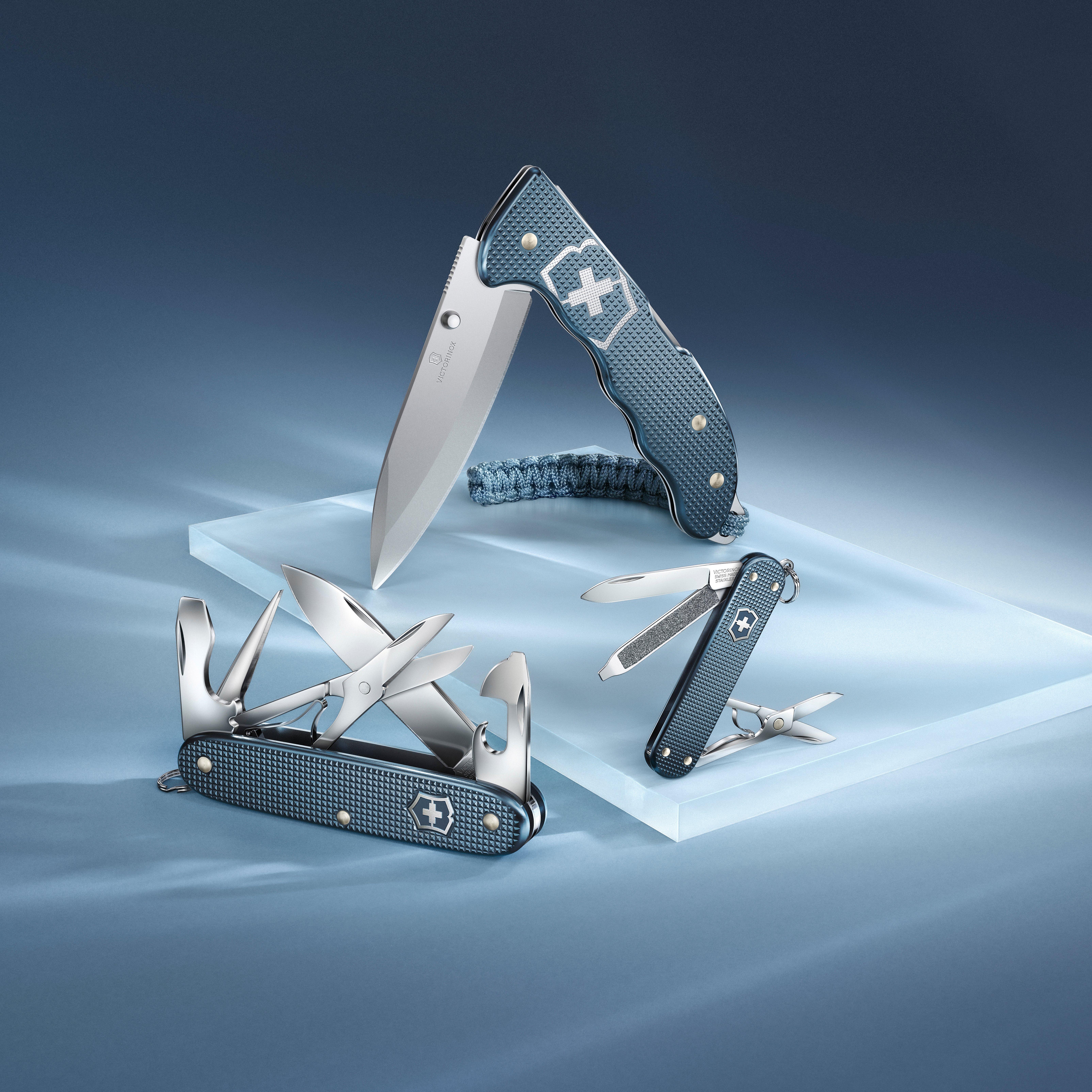 Die drei Victorinox Alox 2026 Limited Edition Glacial Blue Modelle auf einem hellblauen Hintergrund