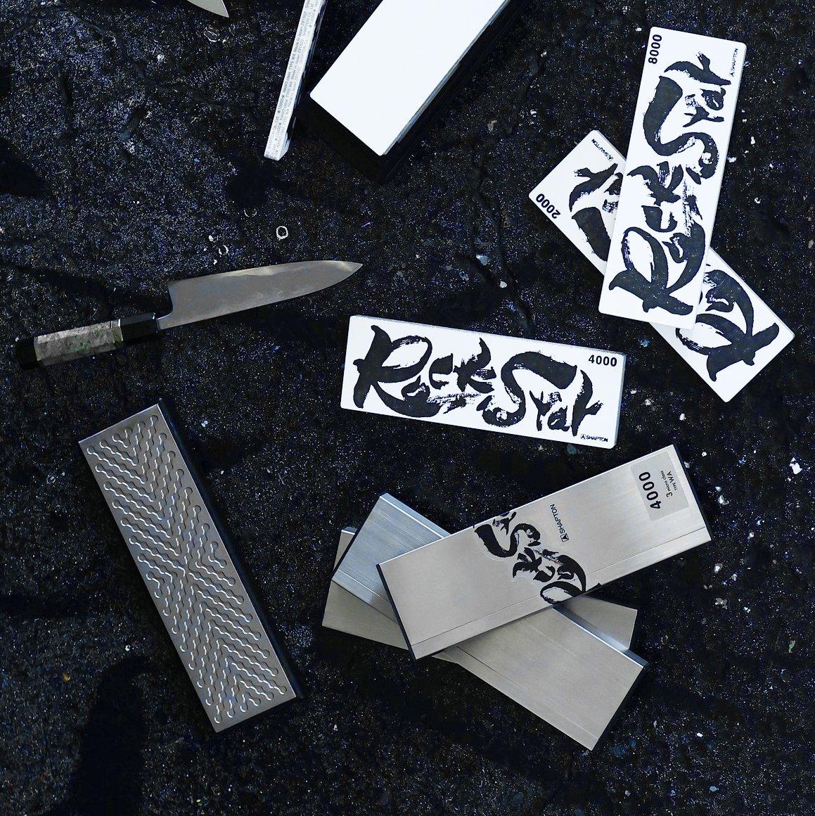 Black and white Shapton Rockstar sharpening stones on a black surface