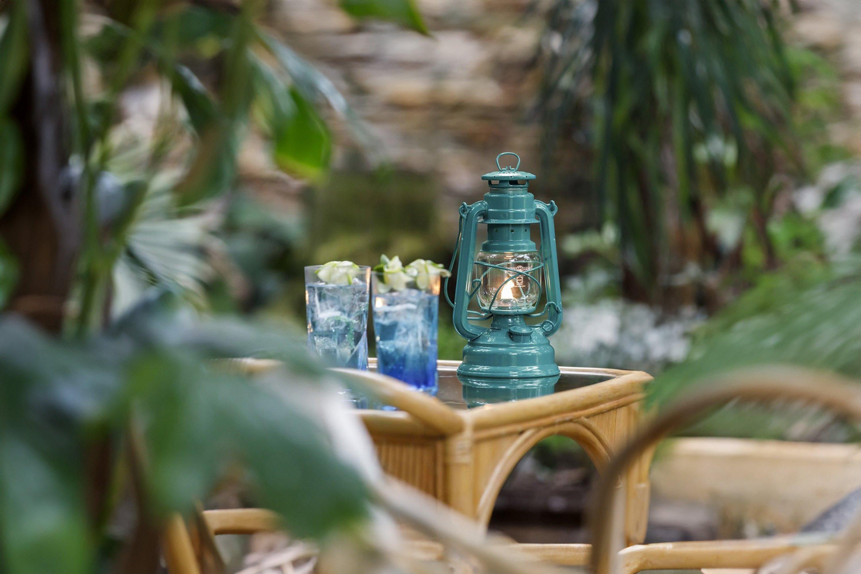 Una lámpara de exterior Feuerhand verde en una mesa