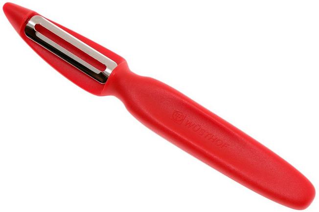 Using a vegetable peeler to remove the skin from a red