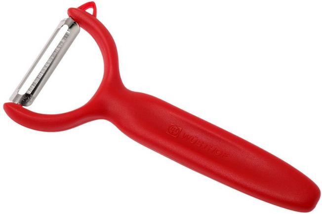 Using a vegetable peeler to remove the skin from a red