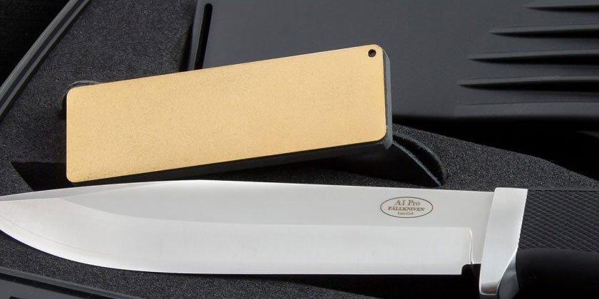 A Fällkniven sharpening stone next to a Fällkniven A1 Pro fixed knife