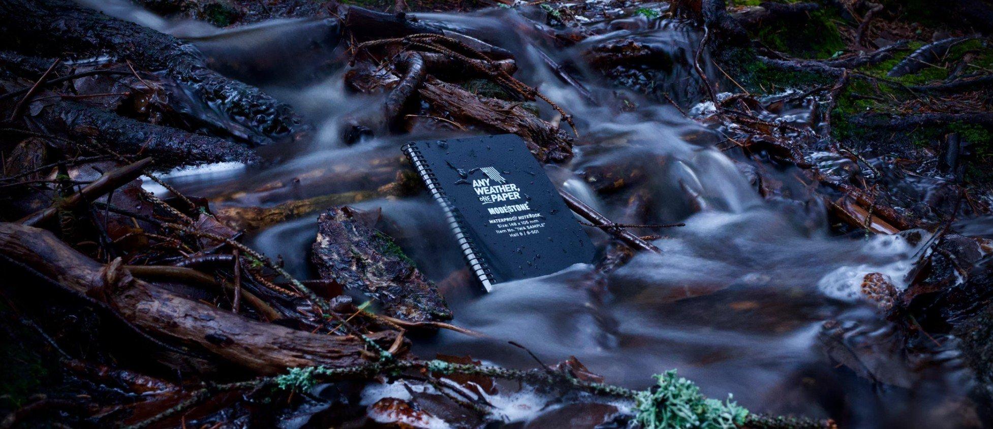 Modestone waterproof notepad open on a damp forest floor